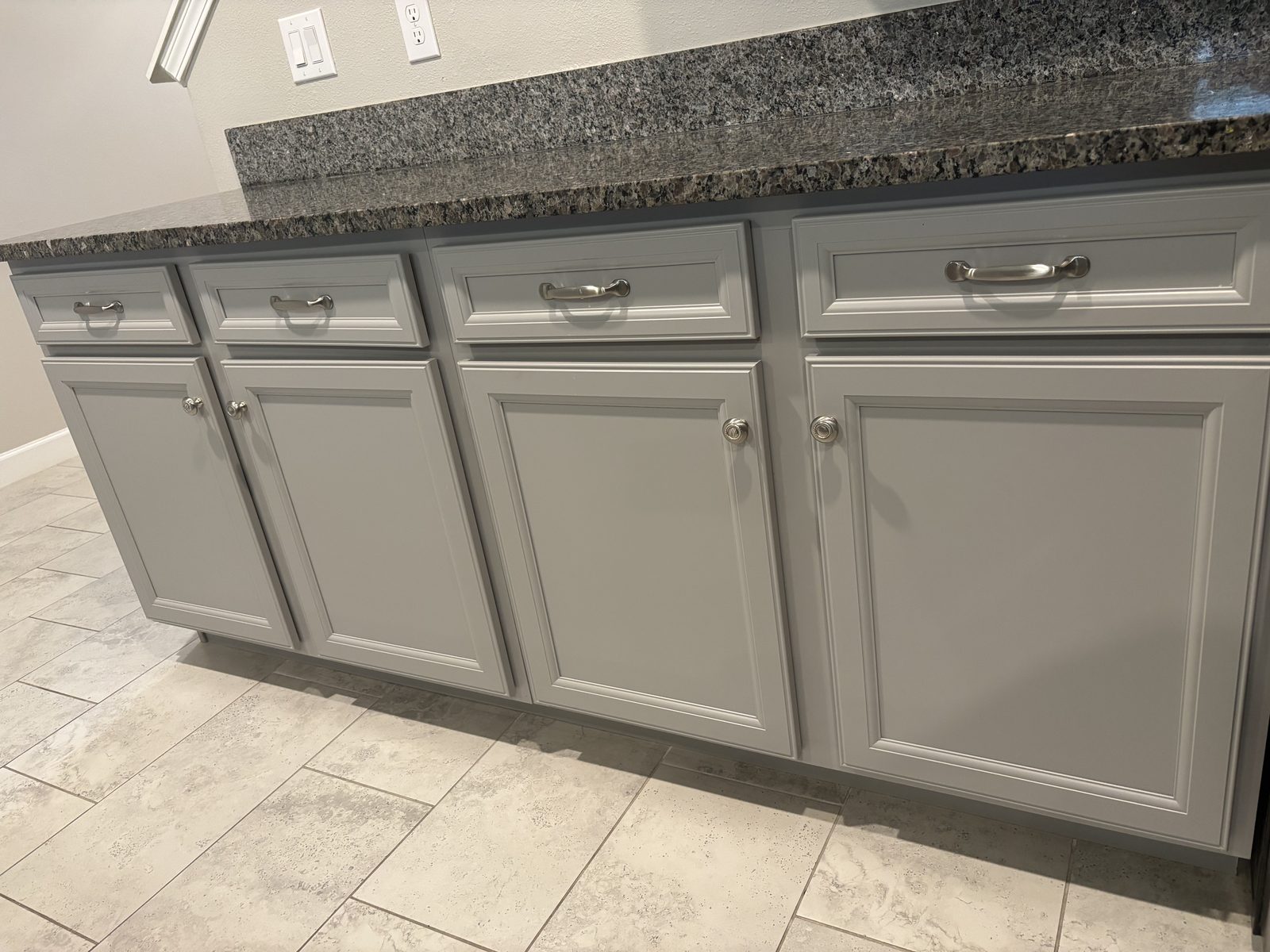 Refinished deep navy blue bathroom vanity with marble top in a Tampa home